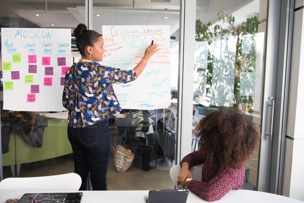An image of a woman leading a meeting.