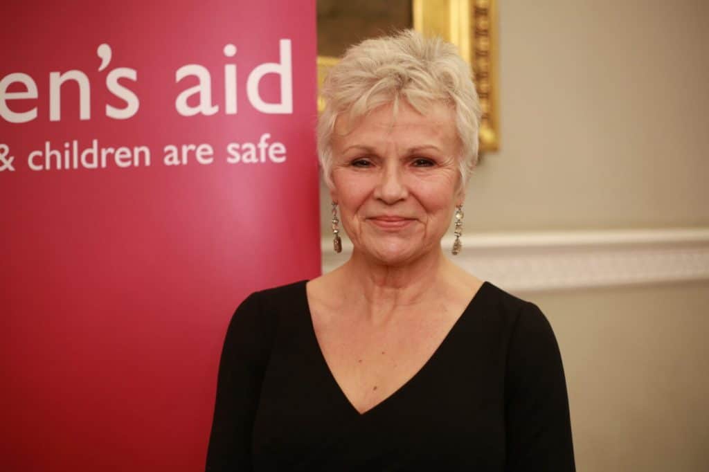 Julie Walters next to Women's Aid sign
