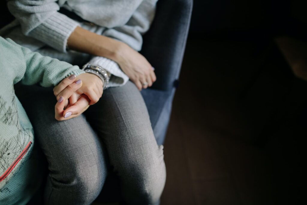 Adult and child holding hands
