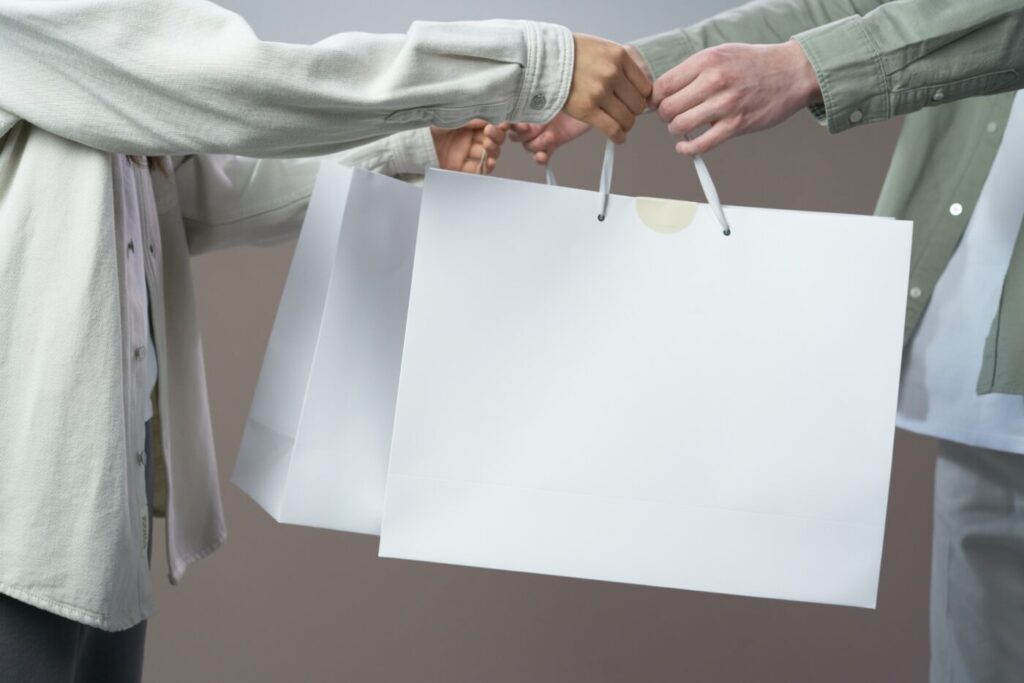 People exchanging white bags