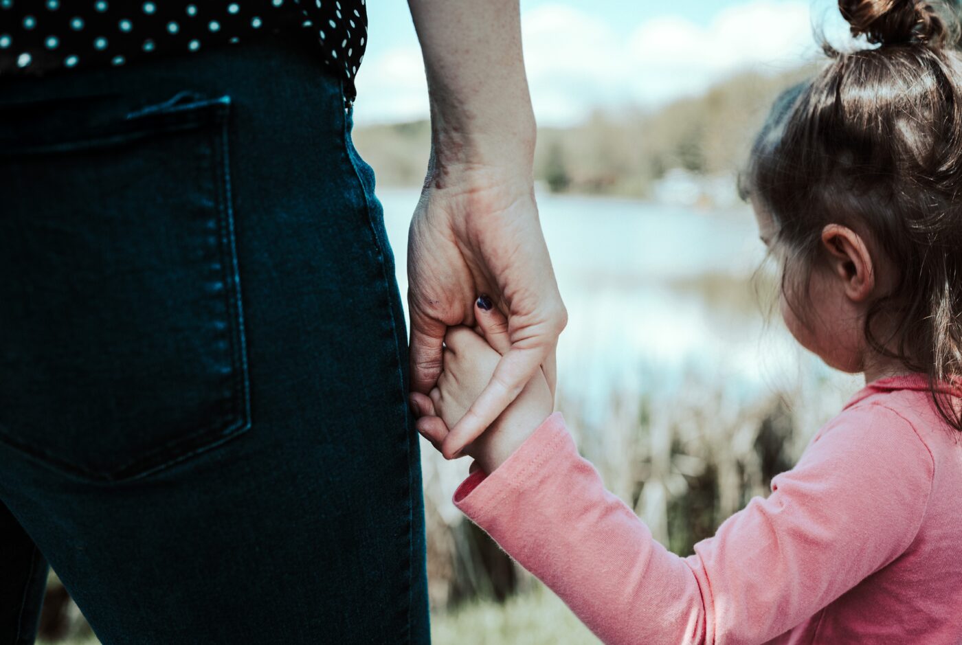 Adult and child holding hands