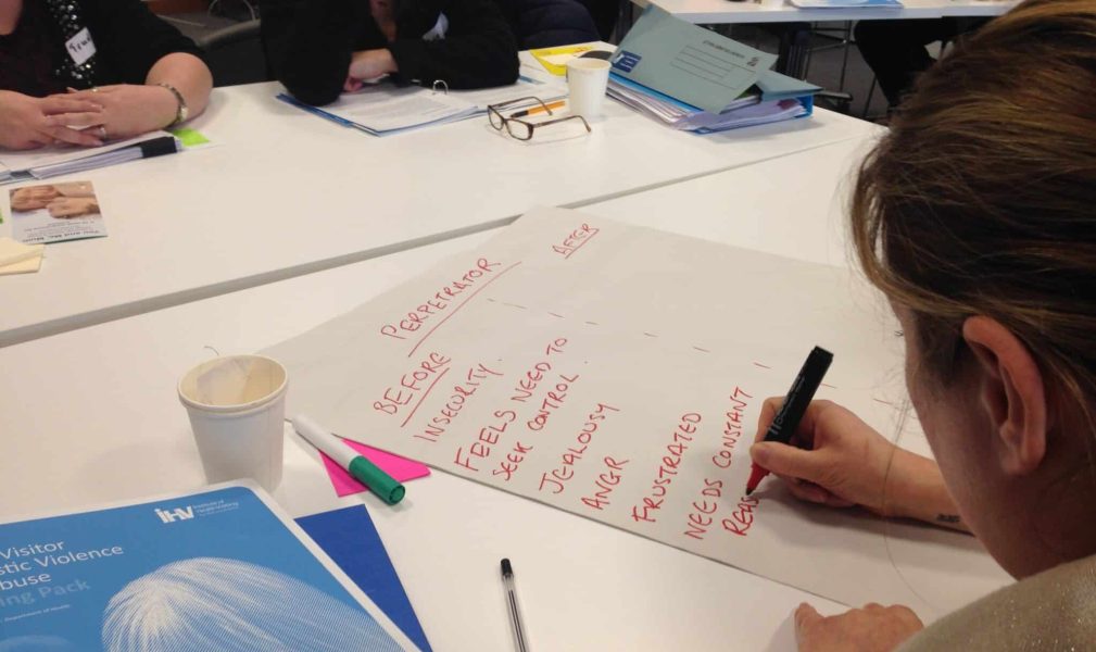 Woman writing on large piece of paper