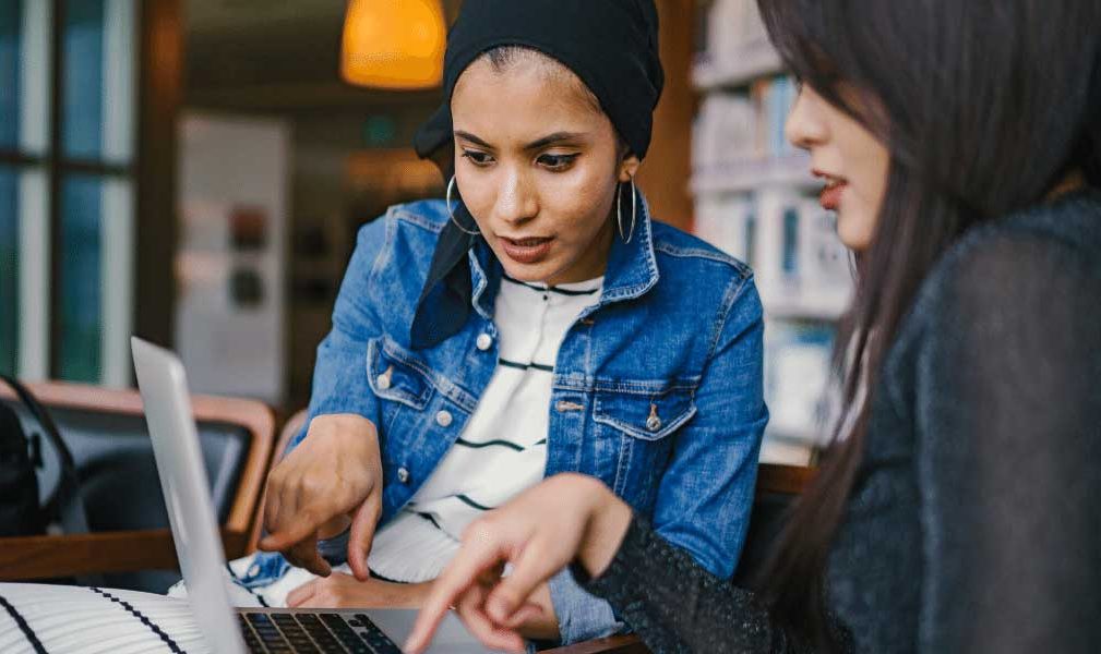 Two women looking at a laptop together